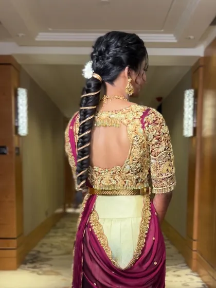 A side view of the modern half-saree drape, showing how the pleats are neatly secured at the waist. This style is both fashionable and comfortable.