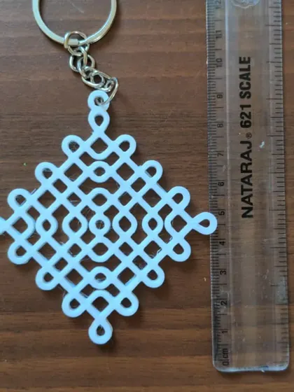 A custom 3D printed keychain with an intricate knot design. This is an example of the personalized items you can create after learning the basics of 3D modeling.