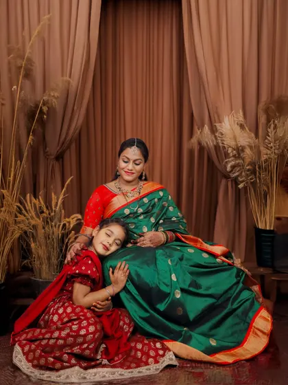 The quiet and tender bond between a mother and daughter, captured in our studio. Dressed in beautiful traditional sarees, this portrait highlights heritage and love against a warm, elegant backdrop.