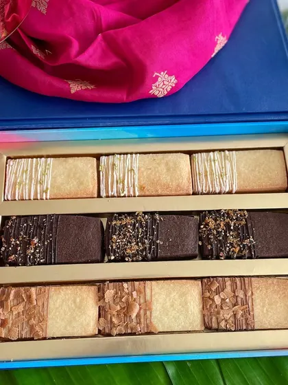This elegant Diwali gift box is filled with my assorted shortbread cookies. The box includes three delicious flavors: lemon-drizzled, chocolate-dipped, and almond-topped, offering a buttery, melt-in-your-mouth experience.