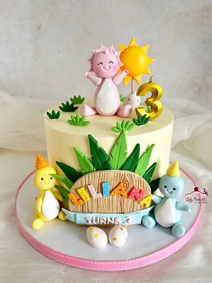 A dino-mite cake for a little girl's 3rd birthday! This design features cute, pastel-colored dinosaurs in a prehistoric party setting.