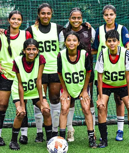 A girls' team in training bibs, ready for a practice match. We provide regular competitive opportunities to sharpen their skills.