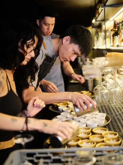 Behind the scenes during our takeover at Reka Bar in Kuala Lumpur. Here, our teams work together, preparing garnishes and setting up for a busy night. This is where the meticulous planning and collaborative spirit come to life.