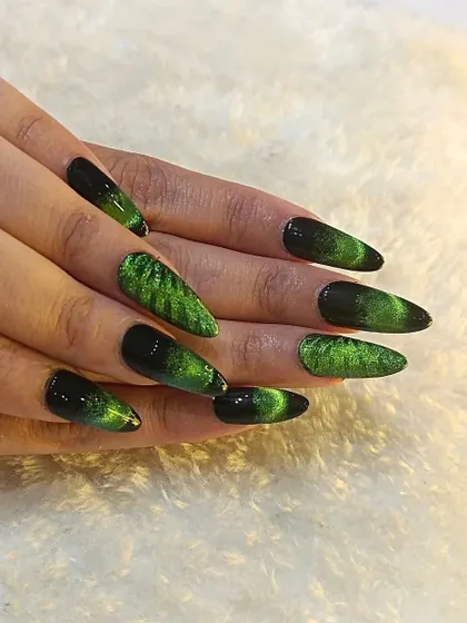 This is the ultimate party look. I created this dramatic green and black cat-eye effect on long, stiletto gel extensions for a client who wanted to make a bold statement.
