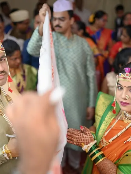 The 'antarpat' moment, capturing the bride and groom seeing each other for the first time during the ceremony.