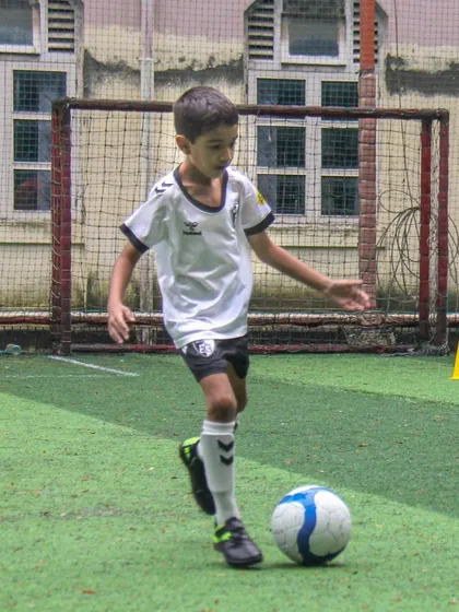 This player navigates a cone drill, a simple yet effective exercise for improving dribbling and control under various conditions.