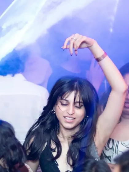 A guest dancing under the blue laser lights, completely in the moment. The combination of lights and music creates a magical experience.