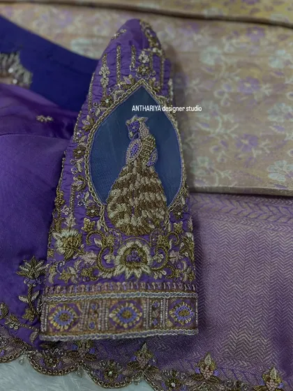 A close-up of the sleeve, showing a beautifully embroidered peacock motif on a sheer window.
