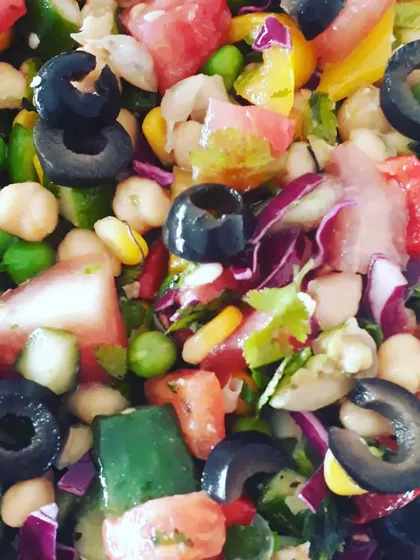 A refreshing and high-protein Mediterranean salad packed with chickpeas, olives, corn, peas, and a variety of colourful vegetables.
