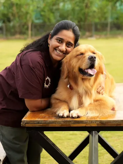 A guest shares a tender moment with a fluffy Golden Retriever, both looking completely content and relaxed.