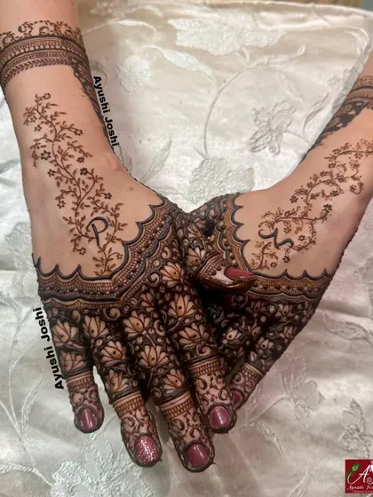 A delicate and modern Roka design, with intricate lotus patterns on the palm and a beautiful floral vine extending up the back of the hand.