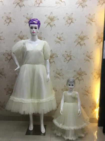 A simple and elegant twinning set in off-white. I used a sparkly net fabric to create these comfortable frocks for a mother and daughter.