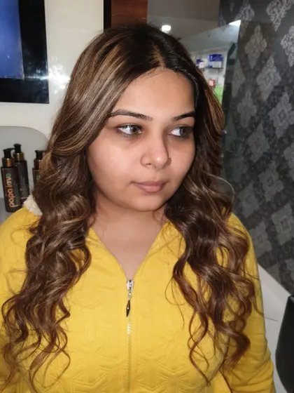 The client's final look with her new caramel highlights. The colour complements her skin tone and adds a beautiful richness to her overall style.