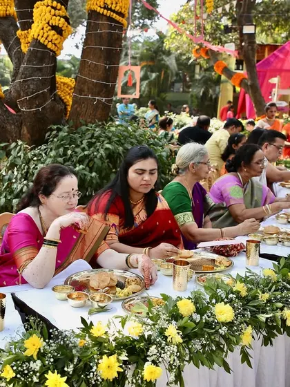 Guests enjoying the authentic Maharashtrian feast during a Pangat. The joy of sharing good food with good company is what makes these events so special.