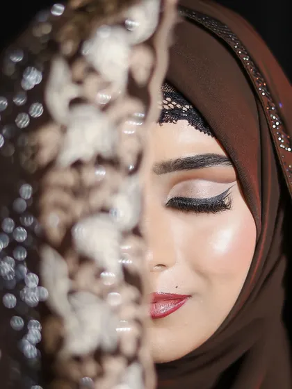 A half-face reveal, highlighting the sharp winged liner and blended eyeshadow of the cut-crease technique.