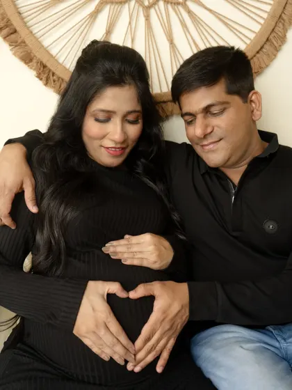 A cozy and intimate couple's portrait in our boho setup. The heart hands gesture is a sweet and direct way to show your love.