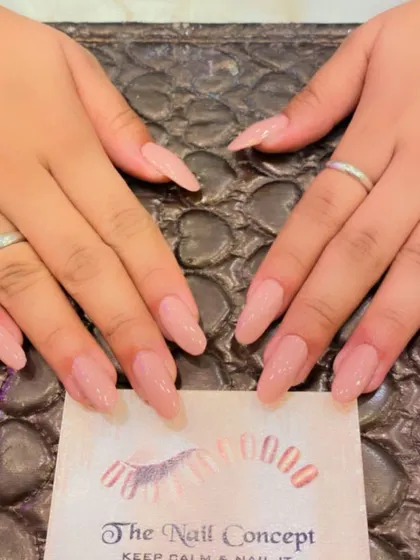A beautiful set of long, almond-shaped nails in a sheer, natural-looking pink. This is a perfect choice for an elegant, "your nails but better" look.