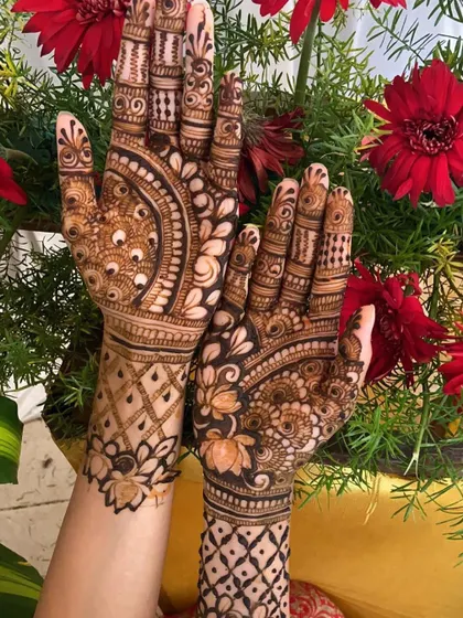 This design incorporates beautiful lotus and peacock feather motifs. It combines traditional Indian elements with a unique layout for a stunning result.