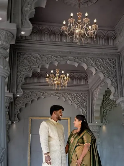 A pre-wedding shoot in a grand, palace-like setting. The intricate architecture and chandeliers add a touch of royal elegance to the couple's portrait.