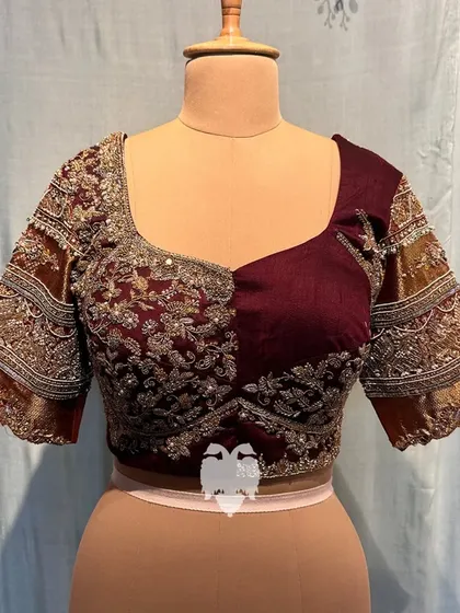 A frontal view of the same blouse, showing the asymmetrical embroidery.