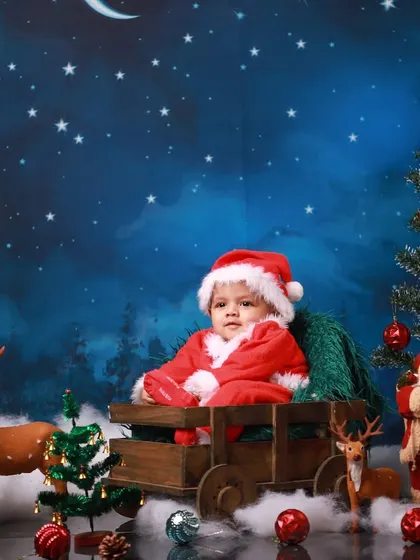 Welcoming the holiday season with a baby's first Christmas photoshoot. This festive Santa setup, complete with a sleigh, reindeer, and a starry night backdrop, is one of my favorite ways to capture holiday magic.