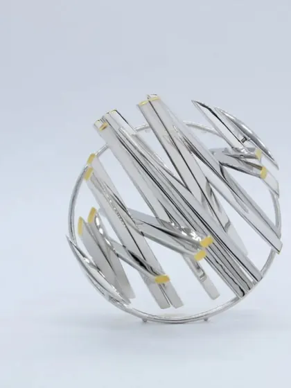 An example of advanced silversmithing, this intricate silver brooch was made by our mentor and serves as inspiration for our workshop participants.