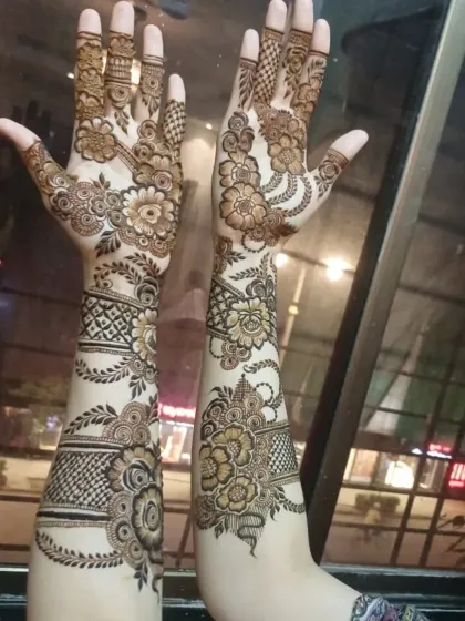 Another angle of the intricate floral arm design, showcasing the shading and fine lines that give the flowers depth.