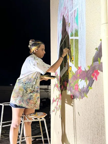 A shot of me working on the terrace mural, with the city skyline in the background.
