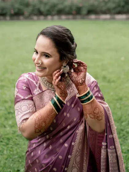 A joyful moment of the bride getting ready. Her makeup is designed to look beautiful from every angle, capturing her happiness.