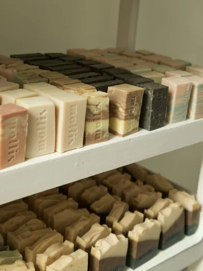 A wider view of the curing shelves, packed with different batches of soap, each with its own unique character.