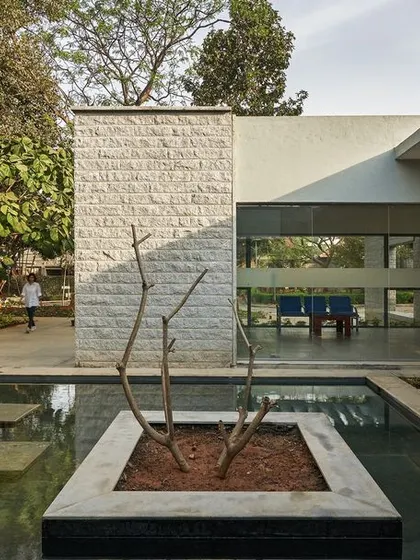 A view across the water court towards the administrative offices. The use of large glass panels and open corridors ensures that the spaces are always connected to the natural surroundings.