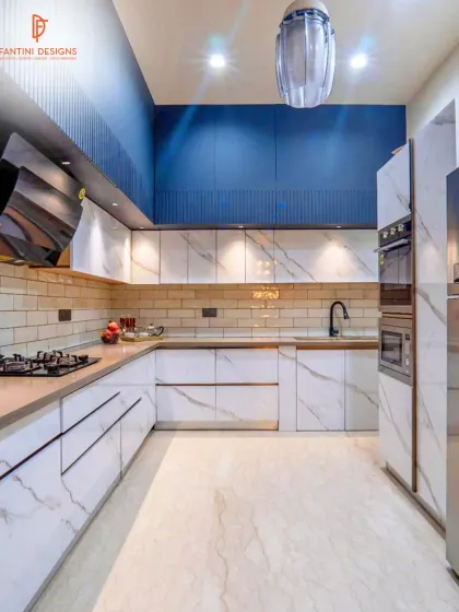 Another angle of the blue and white kitchen, showing the built-in ovens and the ample counter space, designed for both style and serious cooking.