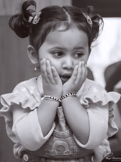 I love using black and white to focus on pure emotion. Without the distraction of color, a child's expressive face becomes a powerful canvas, telling a story all on its own.