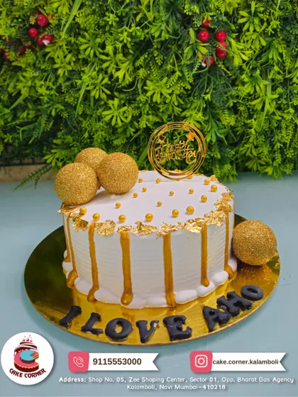 A luxurious white and gold drip cake. Decorated with golden spheres and edible gold leaf, this cake is perfect for celebrating any special moment in style.