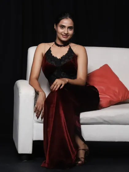 A full-length view of the wine-red velvet dress, showing its comfortable fit and graceful length.