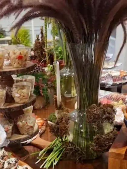 A tall vase rises above our grazing spread at a Bengaluru home, with small portions on stands and platters around it.