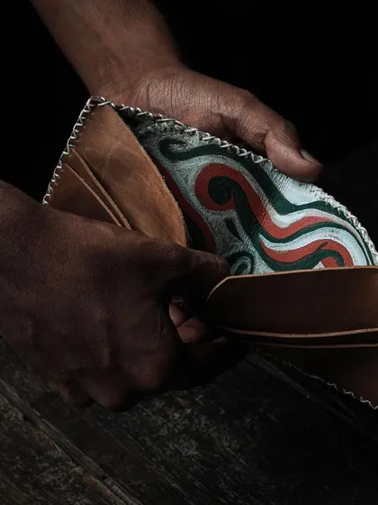 The beauty of handmade leathercraft. This wallet, with its intricate stitching and custom-printed interior, is an example of what you can learn to create. Our workshops guide you through the entire process, from cutting the leather to the final stitch.