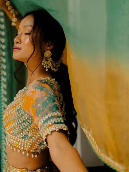 A close-up of the embellished blouse of the tie-dye lehenga, showcasing the intricate beadwork and sequins.