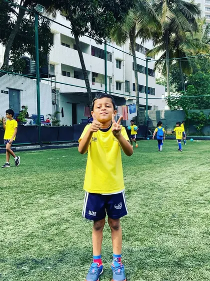 A young player gives a peace sign during practice. We encourage a positive and fun atmosphere where kids feel happy and confident.
