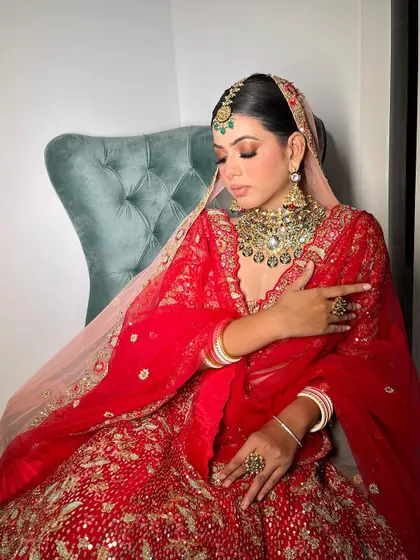 A softer, more romantic angle of this red bridal look. The focus here is on the flawless, dewy skin and the beautifully blended eye makeup, creating a dreamy and ethereal feel.