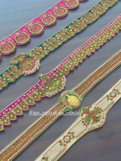 A closer look at the intricate craftsmanship of the embroidered belts.