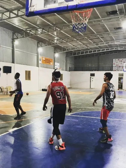 Action under the hoop. This shot captures the competitive spirit we love to see during our court rentals, with players battling for a rebound.