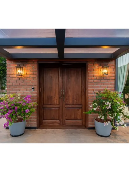 The entrance to the Nandi Hills home features a warm combination of exposed brick and rich, dark wood. This material palette creates a rustic yet sophisticated welcome for residents and guests.