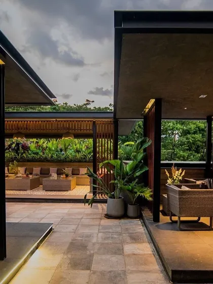 The Chhabria's Terrace project in Bengaluru, showcasing a modern, open-air lounge concept. The design uses a mix of covered and open spaces, creating different zones for relaxation and socializing.