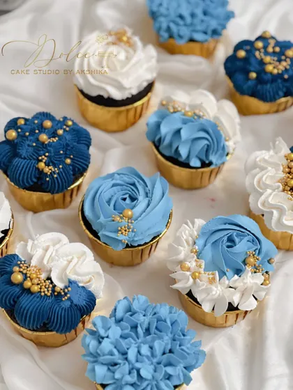 A look at some of my custom cupcakes. I used different piping techniques to create a variety of floral designs in shades of blue and white, finished with a sprinkle of gold. These are perfect for matching a party's color scheme.