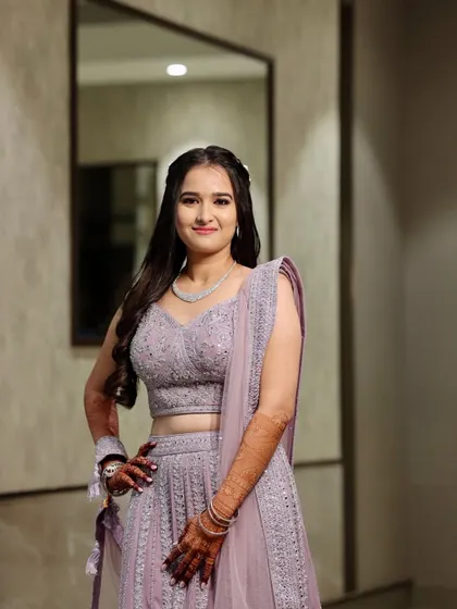 A confident and happy bride. The lilac tones in her outfit are complemented by the soft, cool-toned makeup.