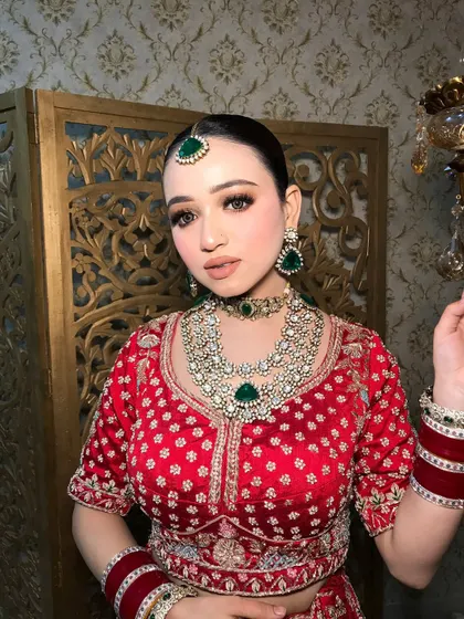 The side profile highlights the contouring and the way the jewelry frames the face.