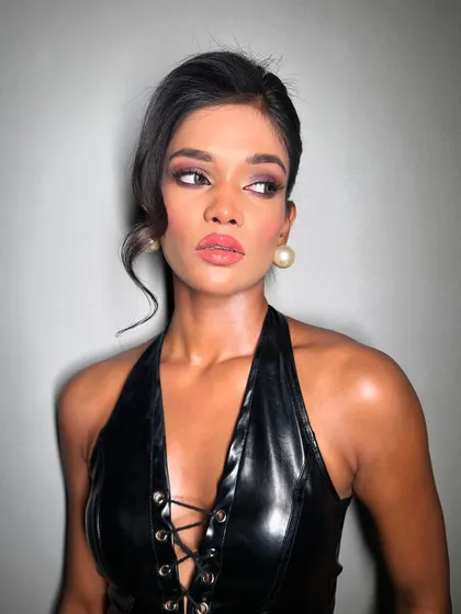 A side profile showing the soft yet impactful eye makeup. The colors are chosen to complement her skin tone, creating a harmonious and stunning look.