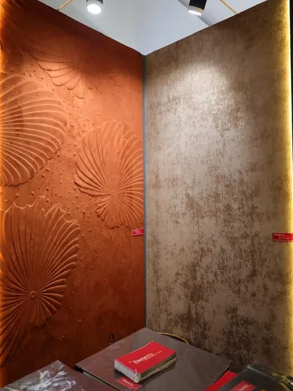 A stunning 3D wallcovering with a large, fan-like floral motif in a rich terracotta color. This design adds a dramatic, sculptural element to the wall, making it a powerful focal point.