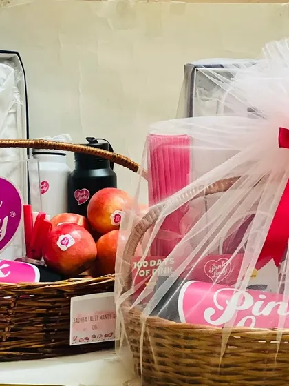Another view of the two 'Pink Lady' gift baskets, highlighting the branded merchandise and fresh apples included.